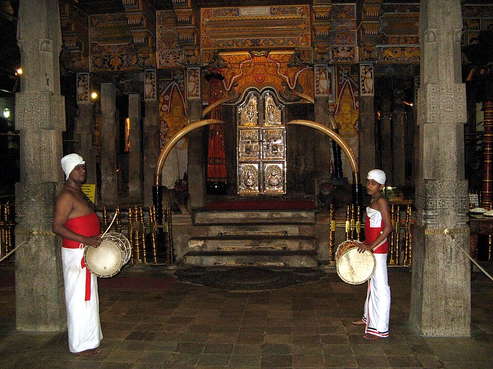 Drummers in white at the Temple of the Tooth in Kandy